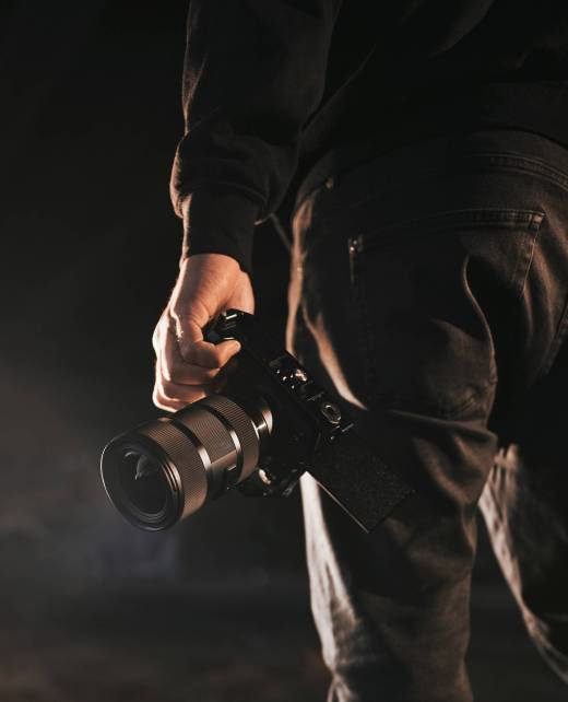 man holds camera. silhouette of videomaker